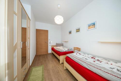a room with two beds and a hallway at Ciasa Piaz de Pavarin in Pera