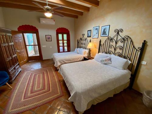 a bedroom with two beds and a ceiling at Hotel Casa María Félix in Álamos