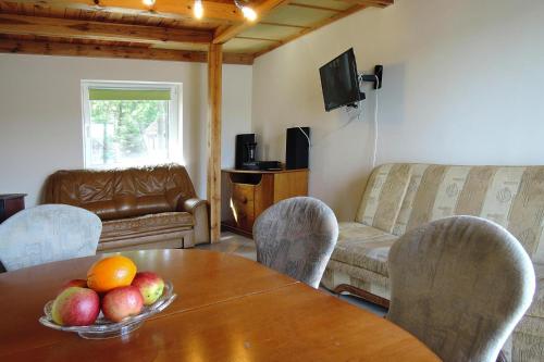 a living room with a table with a bowl of fruit on it at Holiday House in Szczecin at the lake with parking space for 4 persons in Szczecin