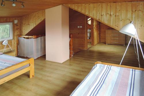 a room with a bed and a staircase in a cabin at holiday home, Kolczewo in Kołczewo