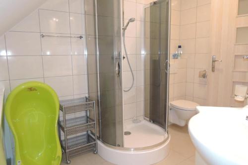a bathroom with a shower and a toilet and a sink at holiday home, Lukecin in Łukęcin