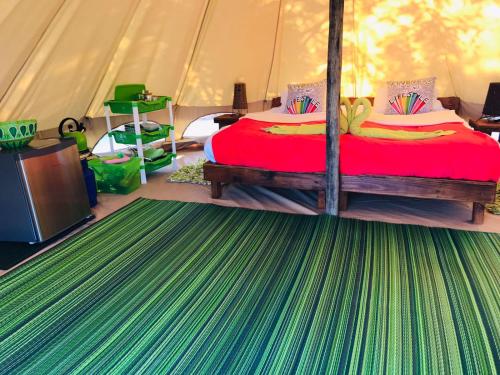 Кровать или кровати в номере Hluhluwe Bush Camp Glamping Village