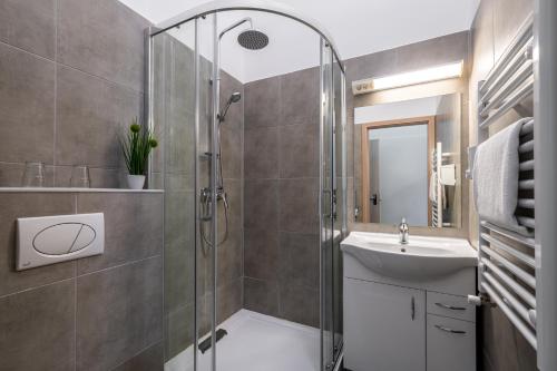 a bathroom with a shower and a sink at Full Moon Budapest in Budapest