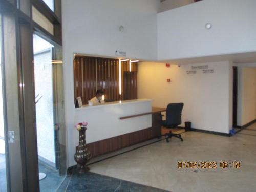 a person sitting at a desk in an office at Hotel Kewal in Nashik