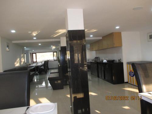 a large room with a kitchen and a living room at Hotel Kewal in Nashik