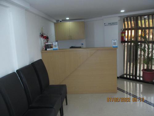 a waiting room with two chairs and a counter at Hotel Kewal in Nashik