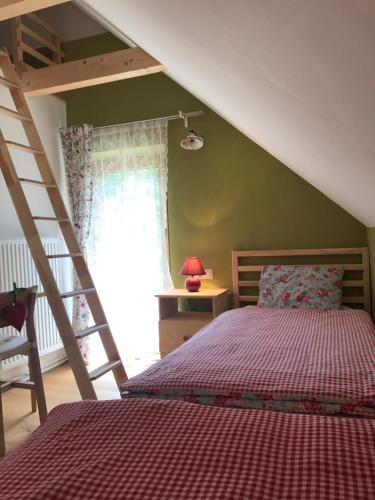 a bedroom with a bed and a ladder at Almhaus Teichalm/Sommeralm in Breitenau