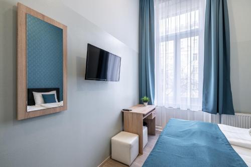 a hotel room with a bed and a mirror at Full Moon Budapest in Budapest