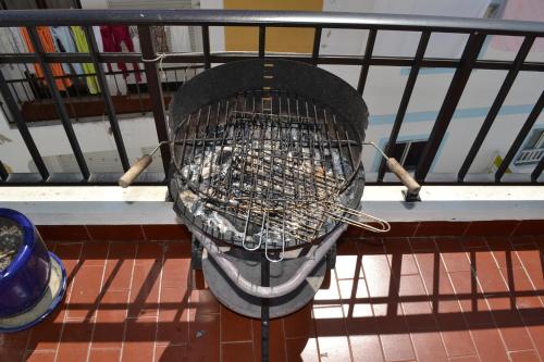 a basket full of sticks sitting on a balcony at Hostel Seixe in Odeceixe