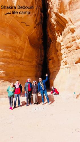 a group of people standing in front of a canyon at Shakria Bedouin Life Camp in Wadi Rum