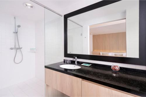 a bathroom with a sink and a large mirror at Shama Central in Hong Kong