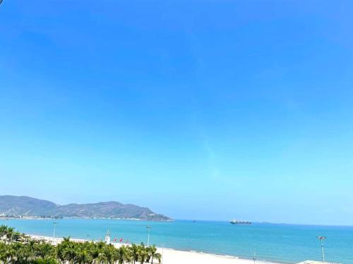 a view of a beach with trees and the ocean at NHATUIshare Quy Nhơn in Quy Nhon