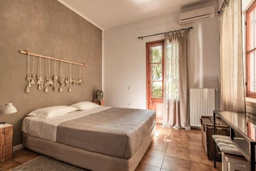 Un dormitorio con una cama grande y una ventana en Villa Gioia - Secret gem with private garden, en Katastárion