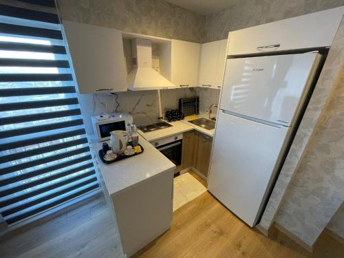 a small kitchen with a white refrigerator in it at King Suite AN9 in Istanbul
