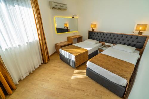 A bed or beds in a room at Kleopatra Celine Hotel