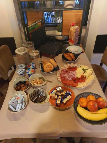 a table with many plates of food on it at Rooms Bolero Naklo in Naklo