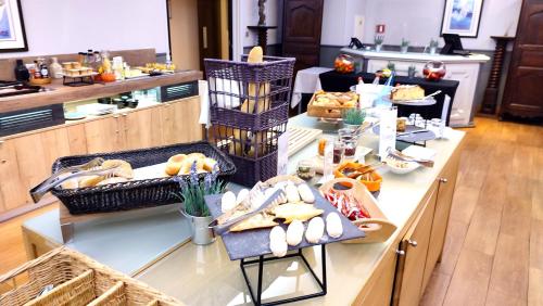 a breakfast buffet with bread and pastries on a counter at Best Western Marseille Aeroport in Vitrolles