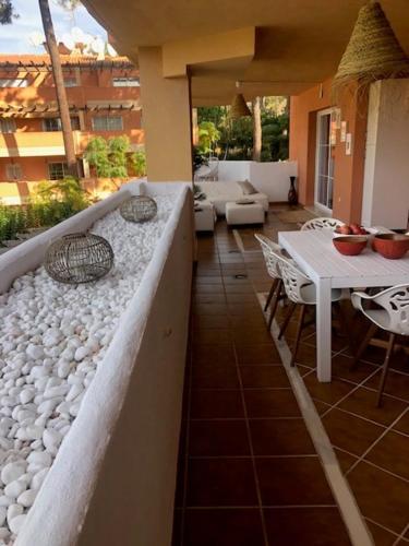 a balcony of a house with a table and chairs at Center beach 2 beds Appartement Elviria in Marbella