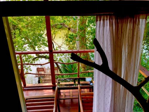 a view from a window of a porch with a tree at Wilpattu Green Cabin in Achchamulai