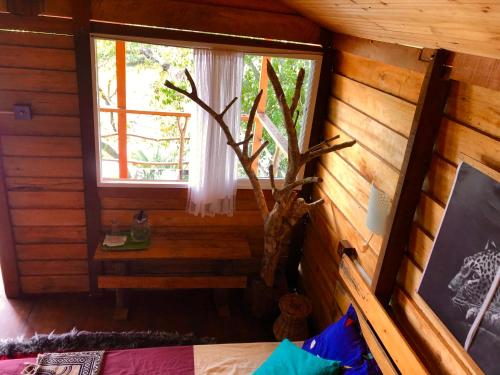 a room with a window in a log cabin at Wilpattu Green Cabin in Achchamulai