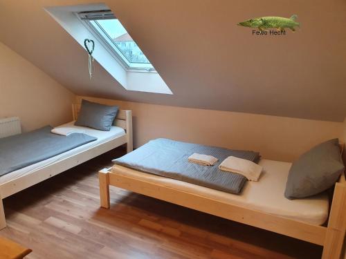 a room with two beds and a window at Fewo Helmstedt in Helmstedt