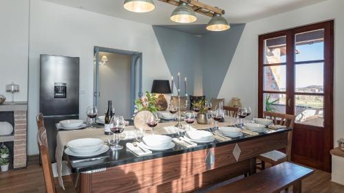a dining room with a table with glasses of wine at CASALE BELLA VITA 8&4, Emma Villas in Città della Pieve