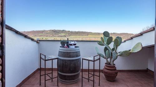 a balcony with a table and chairs and a plant at CASALE BELLA VITA 8&4, Emma Villas in Città della Pieve