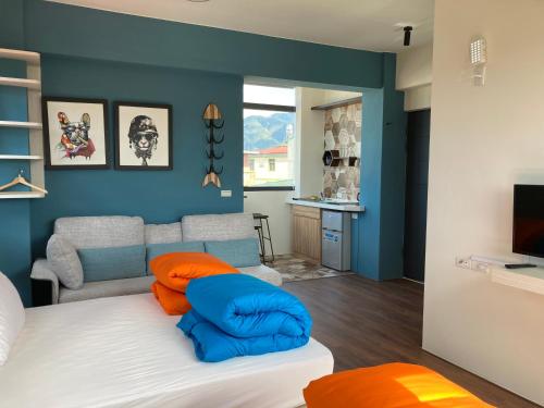 a living room with a bed and a couch at Read to Sleep Book & Bed in Puli