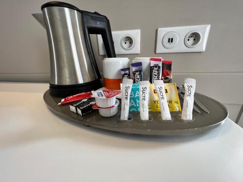 a tray with a cup of coffee, a blender, and other items at Holiday Inn Paris-Auteuil, an IHG Hotel in Paris