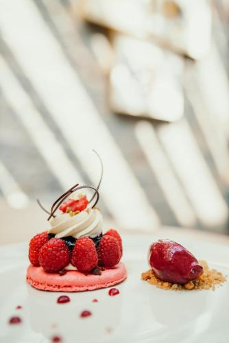 a dessert with berries and whipped cream and a raspberry at Hotel Sanglier in Durbuy