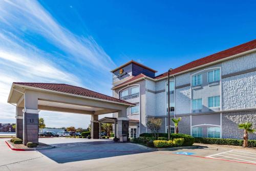 a hotel with a gated entrance with a clock tower at La Quinta by Wyndham Garland Harbor Point in Garland