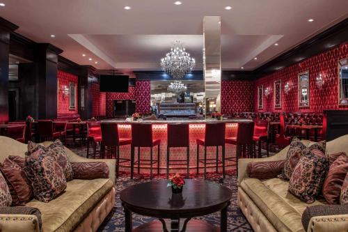a bar in a room with couches and a table at The Antlers, a Wyndham Hotel in Colorado Springs