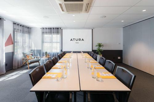 a conference room with a long table and chairs at Atura Wellington in Wellington