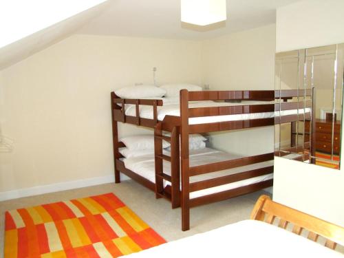 two bunk beds in a room with a staircase at Glendalough 10 Minutes from Beautiful Farmhouse in Roundwood