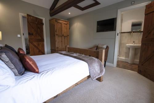 a bedroom with a large bed and a sink at Hill Top Farm 14 in Bainbridge
