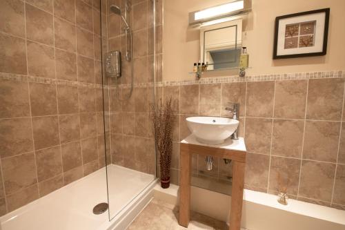 a bathroom with a shower and a sink and a tub at Hill Top Farm 14 in Bainbridge