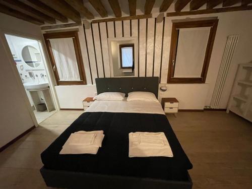 a bedroom with a large bed with two towels on it at Dimora Blu Suite in Venice