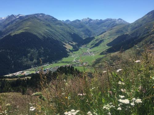 a view of a valley in the mountains at Tgesa Frena in Sedrun