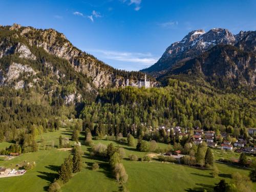 an aerial view of a village in the mountains at Gästehaus Seeklause in Schwangau