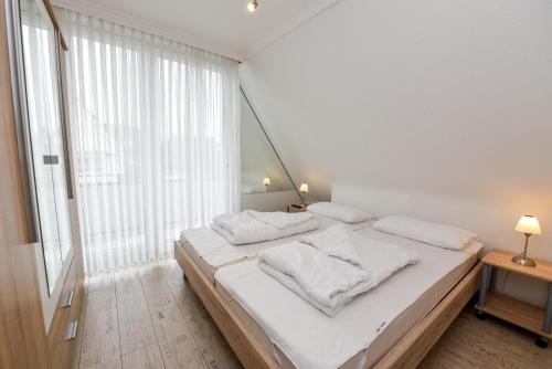 Postel nebo postele na pokoji v ubytování Kapitäns-Hus KH01