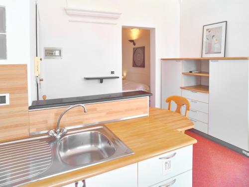 a kitchen with a sink and a refrigerator at Medusa Apartment - Piazza 2 in Finale Ligure