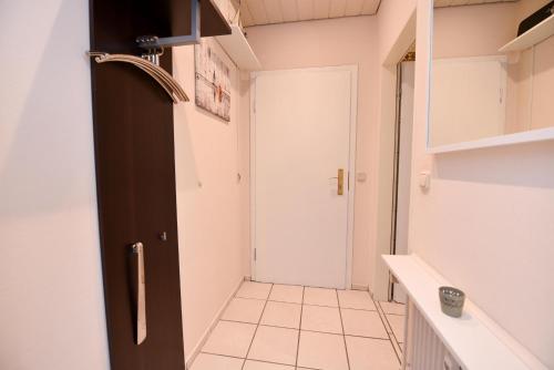 a hallway with a door and a tiled floor at Haus "Najade" Appartement NAJA8 in Döse