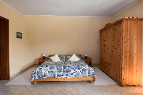 Schlafzimmer mit einem Bett und einem Holzschrank in der Unterkunft Haus "Luv und Lee" Appartement LUV34 in Döse