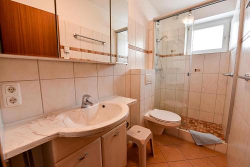 a bathroom with a sink and a toilet at Haus "Nautilus" Appartement NAU08 in Duhnen