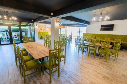 a dining room with wooden tables and chairs at SOMARA in Găineşti