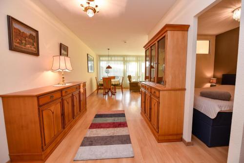 a bedroom with a bed and a desk in a room at Haus "Panorama" Appartement PAN049 in Duhnen
