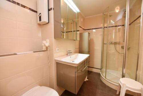 a bathroom with a toilet and a sink and a shower at Haus "Panorama" Appartement PAN049 in Duhnen