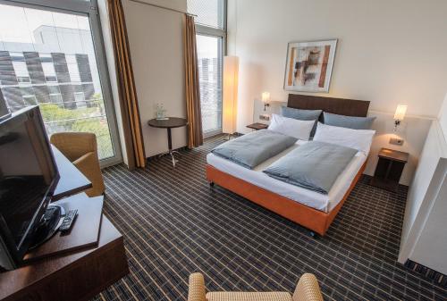 Säng eller sängar i ett rum på Livenwork Hotel & CoWorking GVZ Ingolstadt