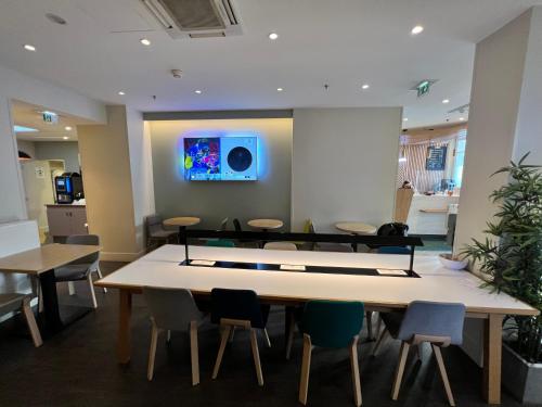a conference room with a ping pong table and chairs at Holiday Inn Paris-Auteuil by IHG in Paris