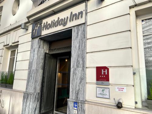 a storefront of a building with a sign on it at Holiday Inn Paris-Auteuil by IHG in Paris